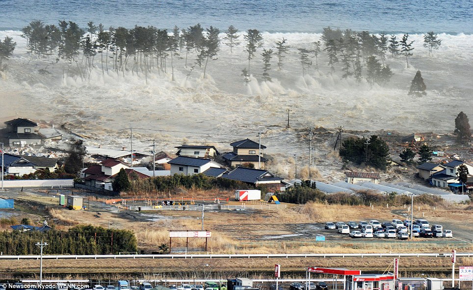 Doomed: A massive tsunami engulfs stranded homes aon the coast of Natori, Miyagi Prefecture, after the earthquake struck